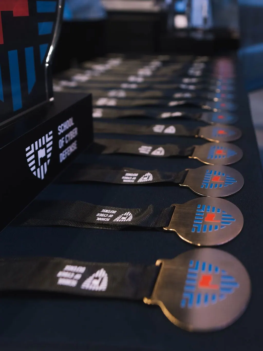 School of Cyber Defense championship medals laid out in a row before the award ceremony